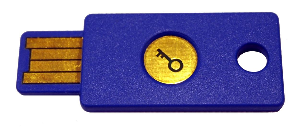 Bright blue, flat, rectangle device with gold metal contacts for plugging into a USB socket. In the middle of the
rectangle is a gold circle with a key symbol on it. There's also a hole so the device can be placed on a key chain.